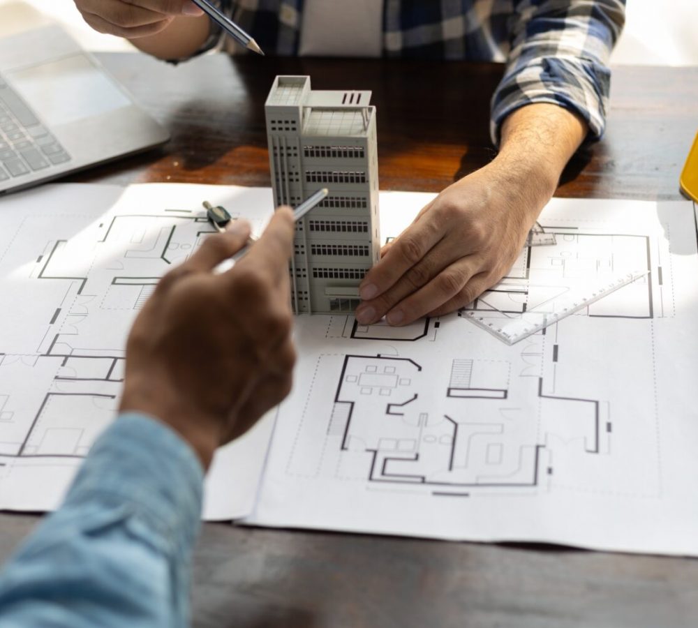Colleague architects in office discussing construction project.