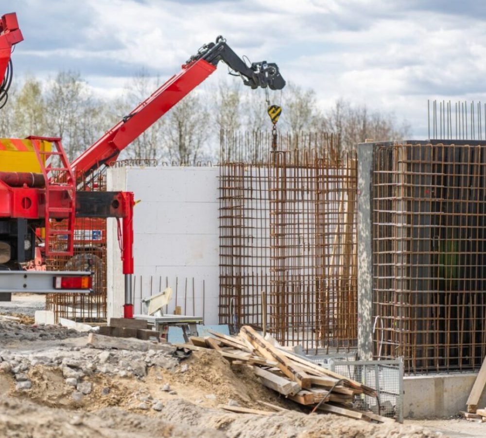 Construction Site With Crane and Concrete Structures in Progress